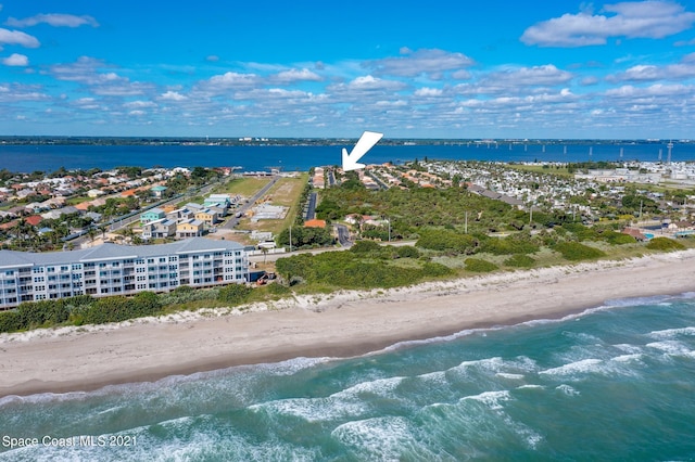 bird's eye view featuring a water view and a view of the beach