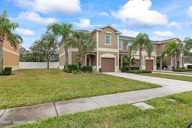 view of front of property featuring a garage and a front yard