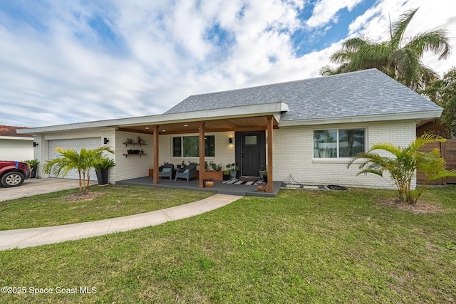 single story home with a porch, a garage, and a front lawn