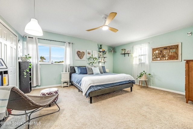 carpeted bedroom with multiple windows, a closet, and ceiling fan