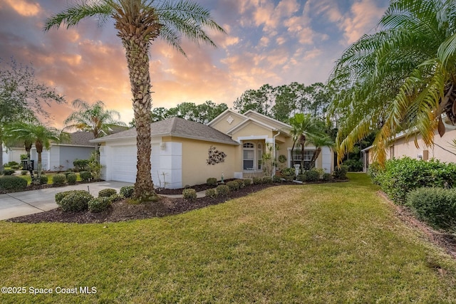 ranch-style home with a garage and a lawn