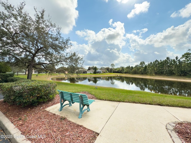 view of property's community featuring a yard and a water view