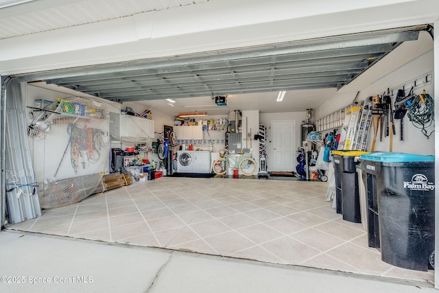 garage featuring washing machine and dryer and a workshop area