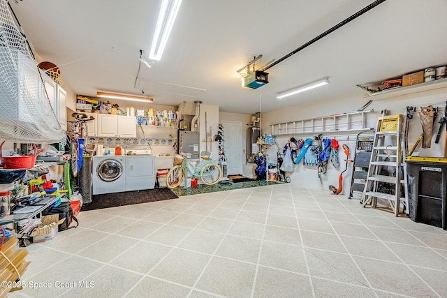 garage with a garage door opener, gas water heater, separate washer and dryer, and a workshop area