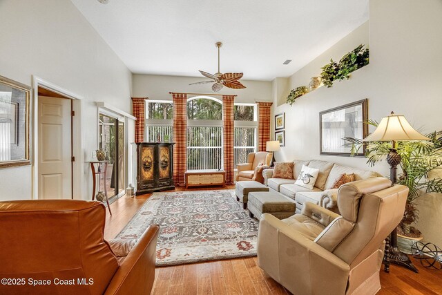 living room with ceiling fan and light hardwood / wood-style flooring