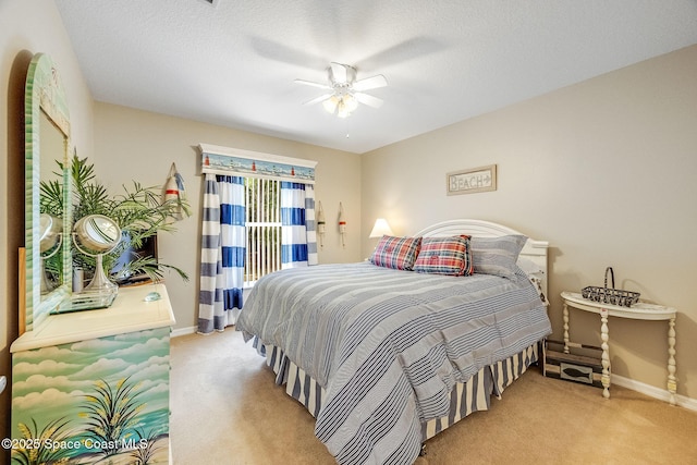 carpeted bedroom featuring a textured ceiling and ceiling fan