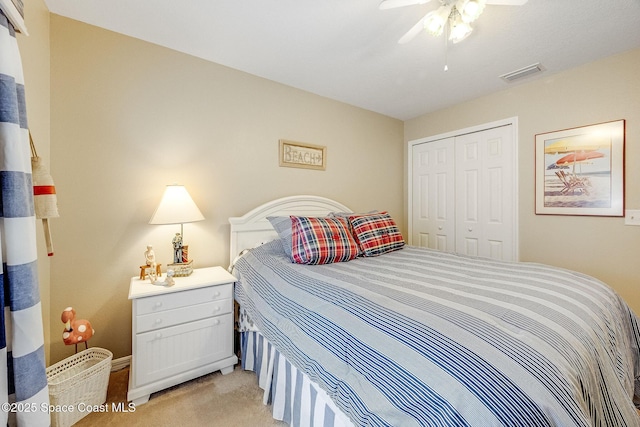 bedroom featuring light carpet, a closet, and ceiling fan