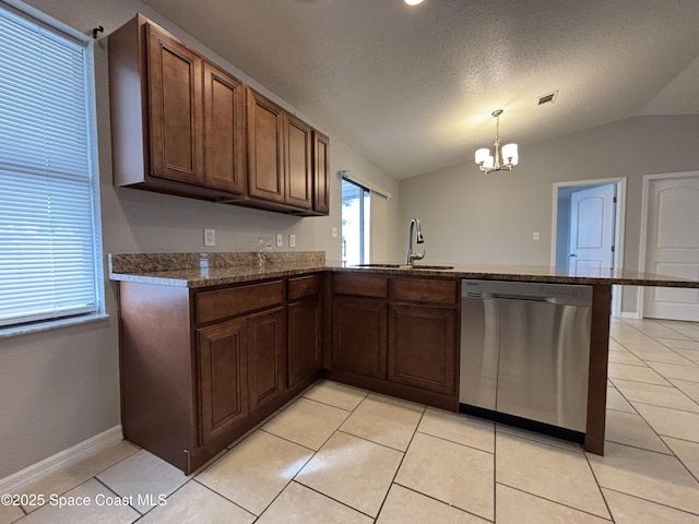 kitchen with lofted ceiling, sink, hanging light fixtures, stainless steel dishwasher, and a textured ceiling