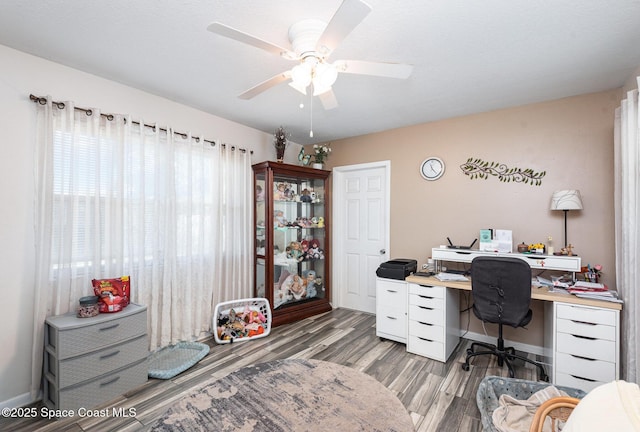 home office with ceiling fan and light hardwood / wood-style flooring