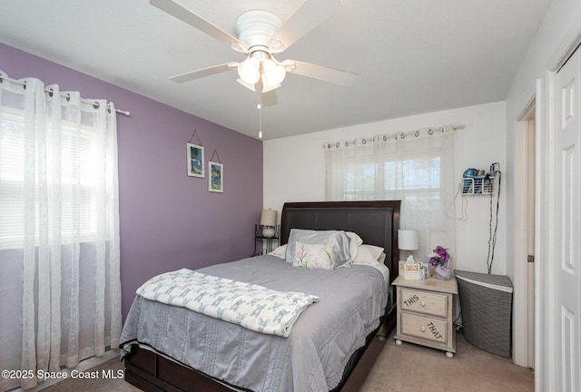 bedroom featuring light carpet and ceiling fan