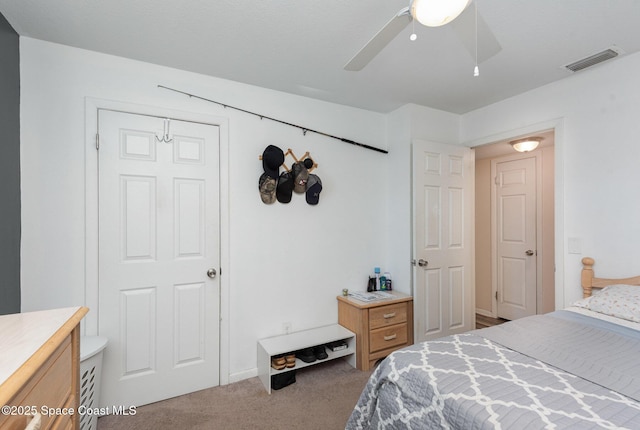 carpeted bedroom featuring ceiling fan and a closet