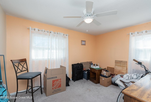 carpeted office with ceiling fan