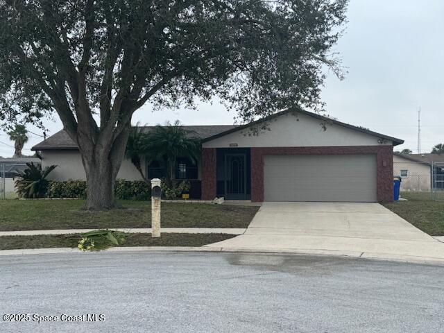 single story home with a garage and a front lawn