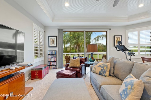 1459 Southpointe Ct, Melbourne, FL 32940 - carpeted living area featuring a tray ceiling, recessed lighting, ornamental molding, and a ceiling fan