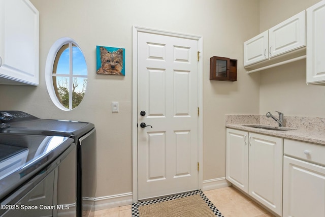 1459 Southpointe Ct, Melbourne, FL 32940 - laundry room featuring independent washer and dryer, baseboards, a sink, cabinet space, and light tile patterned floors
