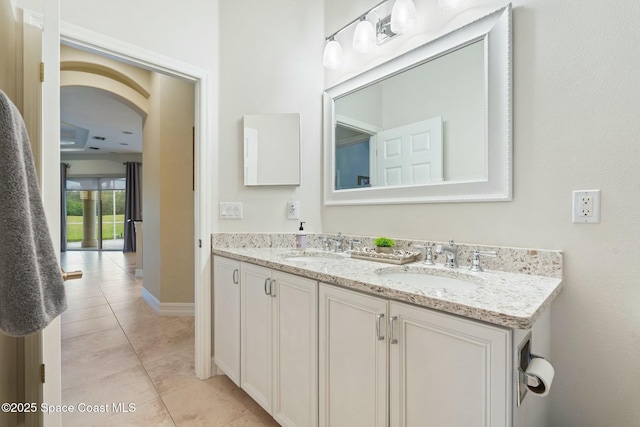 1459 Southpointe Ct, Melbourne, FL 32940 - full bath featuring tile patterned floors, double vanity, a sink, and baseboards