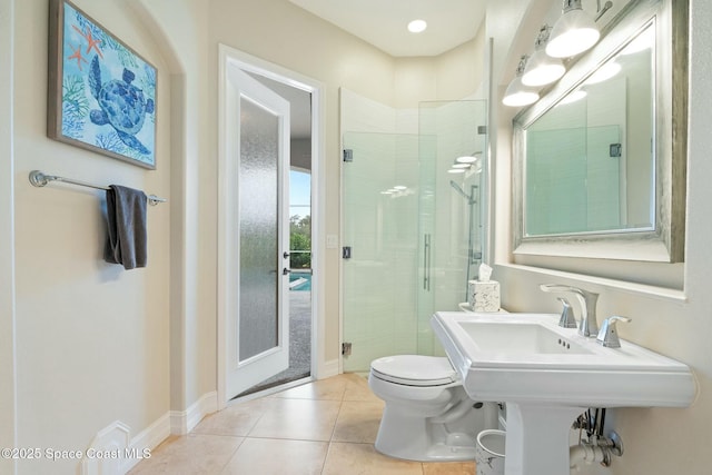 1459 Southpointe Ct, Melbourne, FL 32940 - bathroom featuring tile patterned floors, toilet, a stall shower, and baseboards