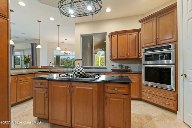 1459 Southpointe Ct, Melbourne, FL 32940 - kitchen with brown cabinets, an inviting chandelier, and appliances with stainless steel finishes