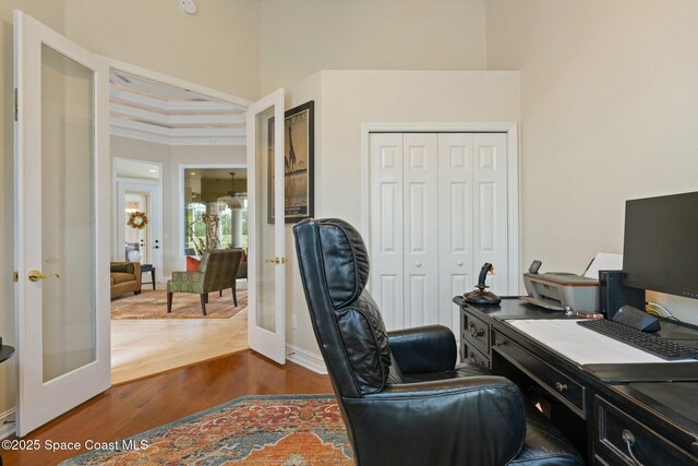 1459 Southpointe Ct, Melbourne, FL 32940 - home office featuring dark wood-style floors, a towering ceiling, and french doors