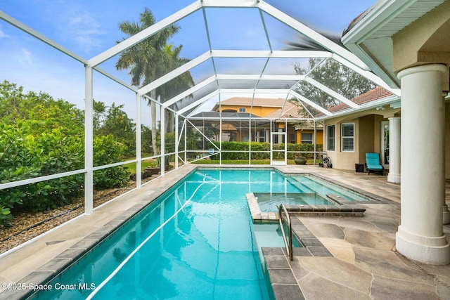 view of pool featuring a patio area and glass enclosure