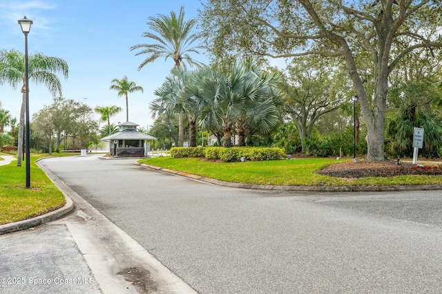 1459 Southpointe Ct, Melbourne, FL 32940 - view of street with a gated entry, street lights, and curbs
