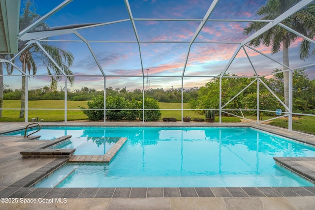 1459 Southpointe Ct, Melbourne, FL 32940 - pool at dusk with a lawn, a pool with connected hot tub, a lanai, and a patio