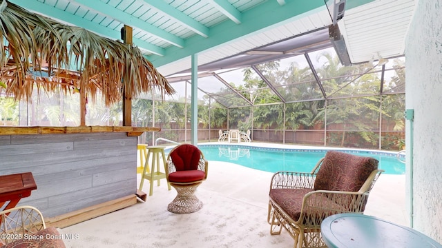 view of pool with a patio and glass enclosure