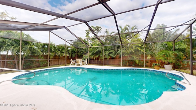 view of swimming pool featuring glass enclosure