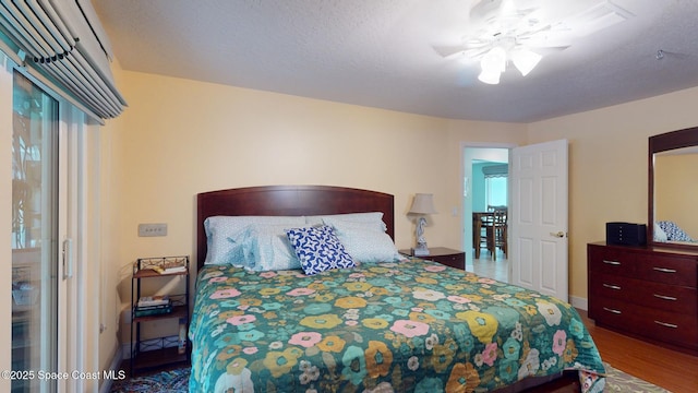 bedroom featuring hardwood / wood-style floors and a textured ceiling