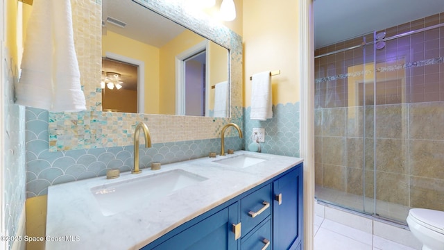 bathroom featuring tile walls, backsplash, vanity, tile patterned floors, and toilet