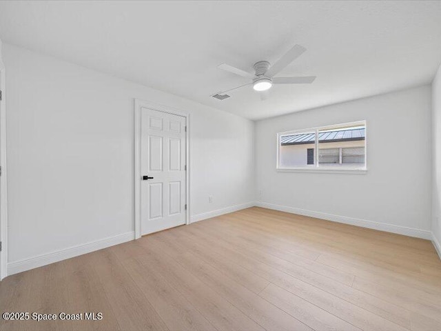 spare room featuring ceiling fan and light wood-type flooring