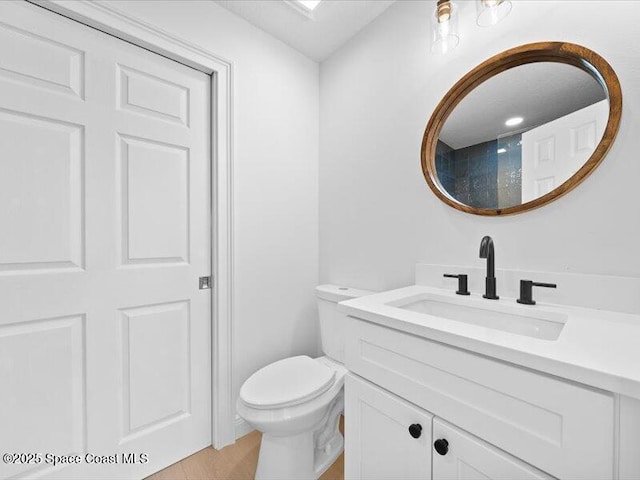 bathroom featuring vanity and toilet