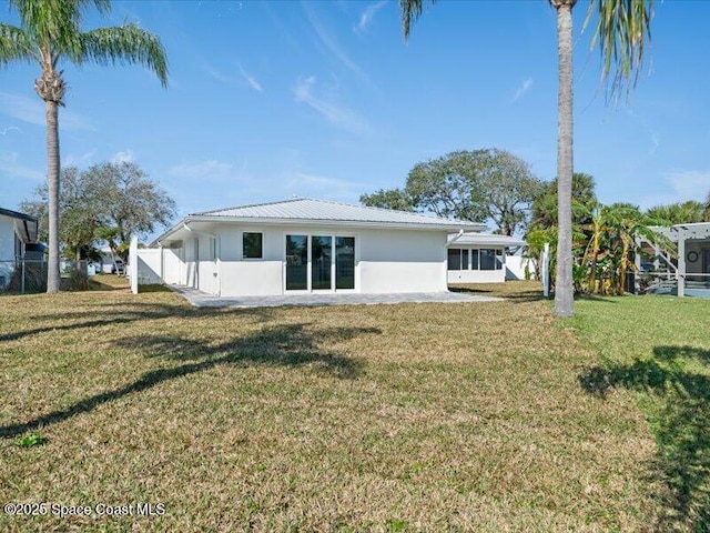 rear view of house with a lawn