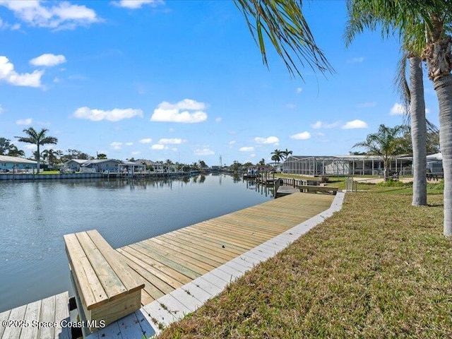 dock area featuring a water view and a yard