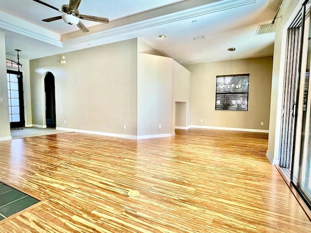 spare room with crown molding, ceiling fan, and light wood-type flooring