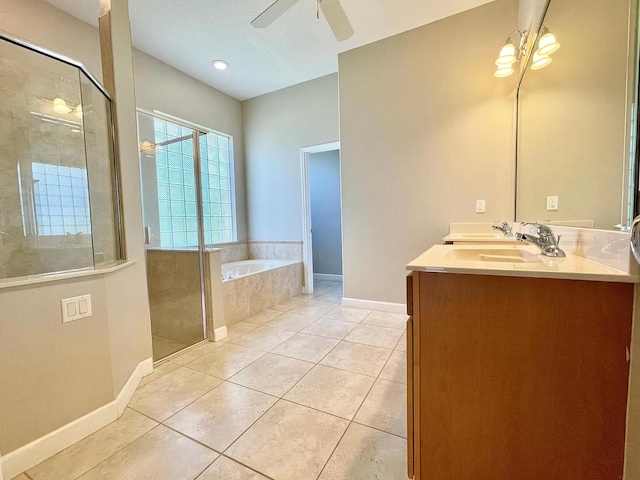 bathroom with ceiling fan, tile patterned floors, plus walk in shower, and vanity