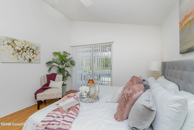 bedroom with hardwood / wood-style floors, lofted ceiling, access to outside, and ceiling fan