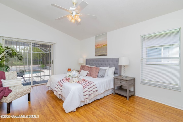 bedroom with hardwood / wood-style flooring, ceiling fan, access to exterior, and vaulted ceiling