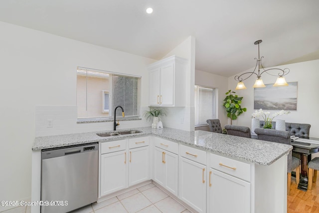 kitchen with sink, dishwasher, white cabinetry, decorative light fixtures, and kitchen peninsula