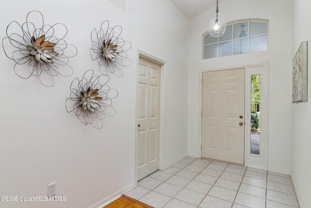 foyer entrance featuring a high ceiling and light tile patterned floors