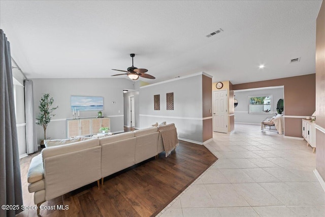 tiled living room featuring ceiling fan