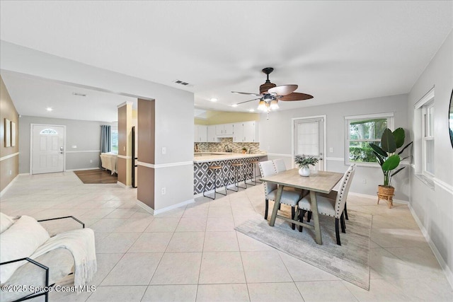 tiled dining room featuring ceiling fan