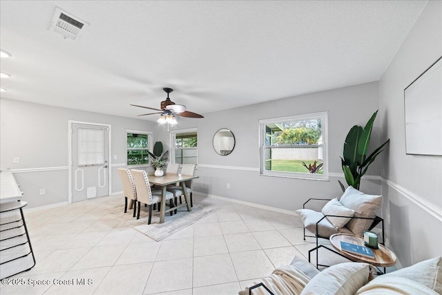 dining room with light tile patterned floors, a textured ceiling, and ceiling fan