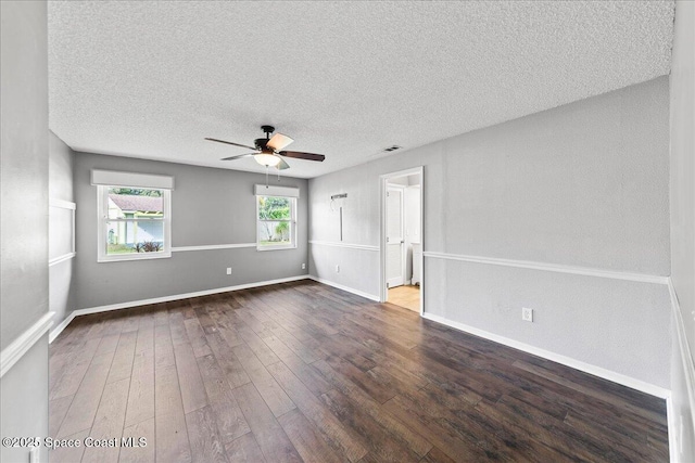 unfurnished room with ceiling fan, dark hardwood / wood-style flooring, and a textured ceiling