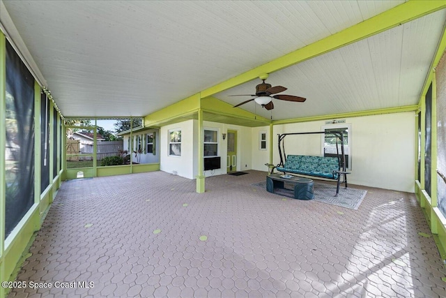 unfurnished sunroom with ceiling fan