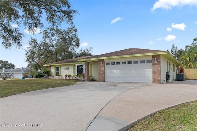 ranch-style home with a garage, central AC, and a front yard