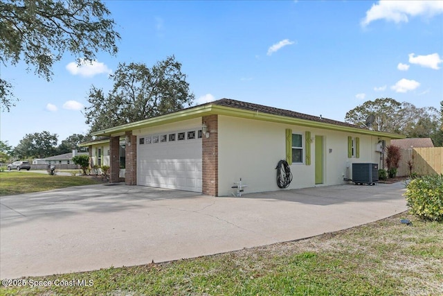 view of home's exterior featuring a garage and central AC