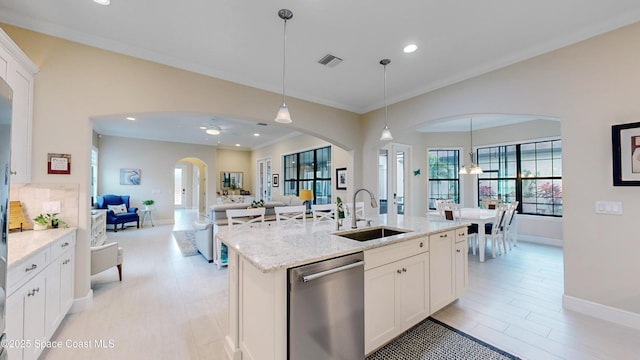 kitchen featuring hanging light fixtures, visible vents, a sink, and stainless steel dishwasher