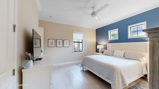 bedroom featuring ceiling fan, baseboards, wood finished floors, and ornamental molding