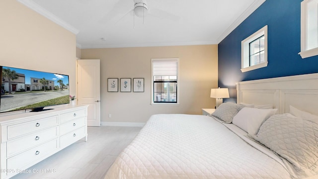 bedroom featuring a ceiling fan, baseboards, light wood-type flooring, and ornamental molding